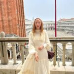 Rebecca Flint Instagram - photodump: Venice 🇮🇹 📍 1. A view from above St Mark’s Cathedral wearing my vintage gunne sax from @elindiovintage ✨ 2. Sun down the canals 3. over 8,000 square metres of mosaics at the cathedral 4. channeling dorothy wizard of oz, or wednesday addams, not sure 5. single file please 6. 1 tea and 1 hot choco price at Caffe Florian 😵‍💫 #vintageprairiedress #70sprairiedress #prairiedressobsessed #prairiedress #charityshopfashion #edwardianfashion #70sdress #softgirl #softgirlaesthetic #romanticstyle #canaletto #neobaroque #canalettoandvenice #canalettovenezia #baroquearchitecture #venicebiennale #18thcentury #historical #historylovers #neoclassicism #venicelife #venezia #veneziaunica #biennaledivenezia #historyofart #historyart #arthistorynerd #classicalpainting #arthistory #classicalart St. Mark's Cathedral