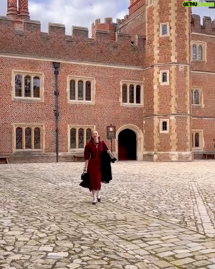 Rebecca Flint Instagram - if you can’t wear a cape in hampton court palace i’m not sure where you can 🌹? I have always wanted to see this incredible tudor palace for myself and I was so excited to have the chance! they had live cooking demonstrations inside the original kitchens, and we saw so many amazing tapestries and paintings… incredible day to visit! the puff headband trend always reminds me of the French Hood so I had to wear this army green one, along with this spectacular velvet and silk cape picked up from @classiccarbootsale in the spring! My dress is vintage from Japan, and my bag is @aspinaloflondon. The shoes are @empressaustralia 🔍 Not forgetting my B necklace as an homage to Anne 🅱️❤️ Hampton Court Palace