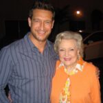 Robert Gant Instagram – I’m sad to hear of the passing of @bettymwhite today. What a wonderful life fully lived. So many people touched and impacted.

When I had the good fortune to work with her on “Hot in Cleveland,” we did what’s called a speed through in the makeup room on taping day. A speed through is essentially the process of whipping through the lines of an entire episode to refresh them quickly before going live in front of an audience. Because it was only the third episode, everyone was especially energized as the show was still finding its feet. Betty’s “date” for the episode was none other than the amazing Carl Reiner, who passed away last year. As we all sat in a circle zipping through our lines, one of my fellow guest stars leaned over and, referring to Betty and Carl, whispered, “Can you believe we’re sitting here doing a speed through with two of the progenitors of comedy?” For indeed we were. And indeed they were.

When we were about to start shooting, Betty came in and found a chair next to me just off the set where we were both to be making our entrances. She sighed a big sigh as she sat, and I said, “How are you doing?” She didn’t miss a beat and asked, “Is it time to go home yet?” I laughed, and we chatted for a bit. I’ll never forget the experience. 

I guess now it really was time to go home. Rest well, Betty. CBS Studios-Radford