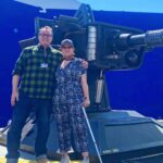 Russell T Davies Instagram - Me & director Chanya Button and a Great Big Gun, in a heatwave. Stand by for Chanya’s masterpiece, as the Toymaker returns and the Earth slides into hell. THE GIGGLE: Who’s laughing now? BBC ONE, Dec 9, 6.30pm 😱🤡💀 @bbcone @bbciplayer @disneyplus @nph @chanyabutton BBC One