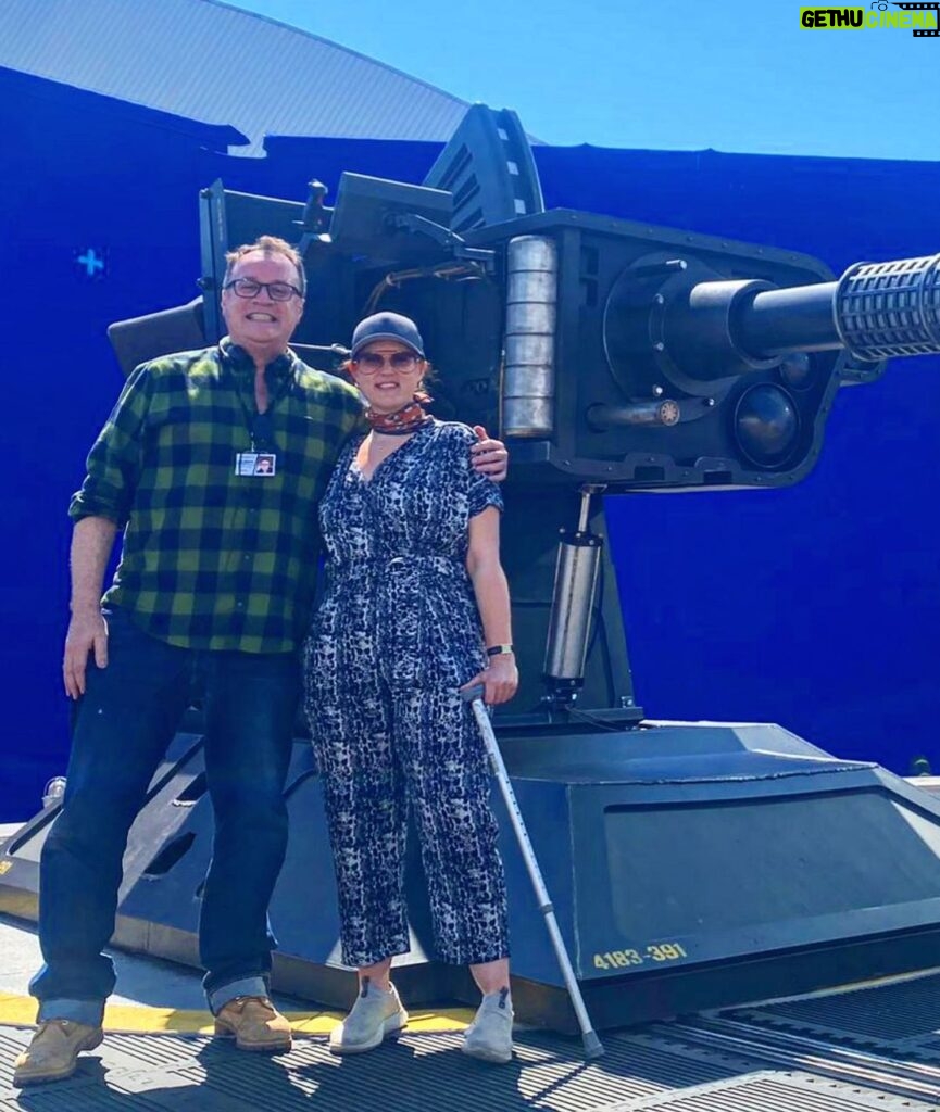 Russell T Davies Instagram - Me & director Chanya Button and a Great Big Gun, in a heatwave. Stand by for Chanya’s masterpiece, as the Toymaker returns and the Earth slides into hell. THE GIGGLE: Who’s laughing now? BBC ONE, Dec 9, 6.30pm 😱🤡💀 @bbcone @bbciplayer @disneyplus @nph @chanyabutton BBC One