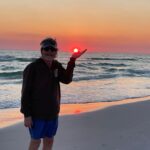 Sam Bush Instagram - Sun in hand, toes in the sand! Sam enjoying some well deserved beach time as 2023 winds down.