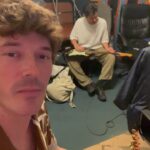 Sam Palladio Instagram - Cooking up some tunes in London with @connors_danny & @andyhallhall. Using an AA battery as a slide guitar Battersea Power Station