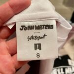 Seth Bogart Instagram - What an honor to design 3 collections of merchandise for the great new John Waters “Pope of Trash” show at @academymuseum ‼️ Seeing my art all huge on 2 walls at the end of the exhibit blew my mind. Love this pic @greggormanphoto took of John in front of my drawing of him. Just wait til you see the whole bathroom collection & the Divine/Pink Flamingos collection - both of those will be dropping sometime soon. Go see the show !!! Academy Museum of Motion Pictures