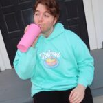 Shane Dawson Instagram - I like having his name on my chest so the zero people that hit on me know that I’m taken. 💪🏻🐷👍🏻 New Ryland hoodie and pink pig cup up now on my merch site! (link in bio) ❤️