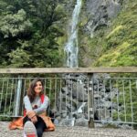 Shirley Setia Instagram - After what felt like a million steps later- saw this pretty lil waterfall 🌈💫 Since everyone keeps asking me photos koun le raha hai 📷: my phone & my tripod ✌🏻😅📱 #shirleytravels #shirleysetia #newzealand #arthurspass #southisland Arthur's Pass National Park