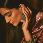 Sonam Kapoor Instagram – Wearing this @jigyam ensemble is what Indian textile dreams are made of!
it’s my bffs wedding and this was the perfect chance for me to wear a beautiful outfit that was made from actual vintage old banarasee  saree with real gold weave with all antique techniques of surface embroidery; they have added all vintage tassels with shells and pearls  and the dupatta is embroidered with vintage mochi work pieces which are over 60 years old and is one of the finest techniques of embroidery from Gujarat.
All the silver jewellery are actual antique pieces which have been collected over a period of time and payal and bangles are more then 80-90 years old antique pieces!

Anand on the other hand is wearing gorgeous resham work kurta  from @abujanisandeepkhosla which is a collectible heirloom. Each piece of theirs takes months to make.

My jutti is @fizzygoblet and Anands is @rajeshpratapsinghworks 

📸 @sheldon.santos 

#madeinindia #everydayphenomenal💫 #proudindian #textileheaven