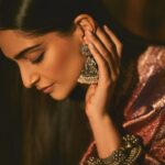 Sonam Kapoor Instagram - Wearing this @jigyam ensemble is what Indian textile dreams are made of! it’s my bffs wedding and this was the perfect chance for me to wear a beautiful outfit that was made from actual vintage old banarasee saree with real gold weave with all antique techniques of surface embroidery; they have added all vintage tassels with shells and pearls and the dupatta is embroidered with vintage mochi work pieces which are over 60 years old and is one of the finest techniques of embroidery from Gujarat. All the silver jewellery are actual antique pieces which have been collected over a period of time and payal and bangles are more then 80-90 years old antique pieces! Anand on the other hand is wearing gorgeous resham work kurta from @abujanisandeepkhosla which is a collectible heirloom. Each piece of theirs takes months to make. My jutti is @fizzygoblet and Anands is @rajeshpratapsinghworks 📸 @sheldon.santos #madeinindia #everydayphenomenal💫 #proudindian #textileheaven