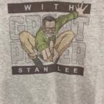 Stan Lee Instagram – 💥 With Great Power 
💥 Excelsior!
💥 ‘Nuff said!

What catchphrase would you put on your own Stan Lee tee? 

Today’s your last chance to create a one-of-a-kind custom t-shirt or water bottle at our LA Comic Con booth — until 5pm!

There’s more! Show our staff at booth 1127 this video and get 10% off your apparel purchase. 😎

#StanLee100 #StanLee