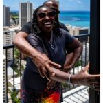 Stephen Hill Instagram - "The One-Heart Way" She was shook! But Sensei Kenny had her back. She also hopped off the Lanai immediately after this photo op. Fam since the days of Isshinryu Karate. We go waaaaaay back. Harlem in Honolulu. #stephenhillphotos #hawaiilife🌺 #lanai #joy #leicaphoto #isshinryukarate #theoneheartway #harlem