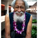 Stephen Hill Instagram - First and Last Unko As I was leaving the Blaisdell yesterday, an Aunty asked me, "Who are you? You have on a Lei, so you must be somebody." She took off so fast I couldn't take it off and give it to her. So I waited a few minutes and when Uncle walked out with his guitar in tow I gave it to him. I asked if he enjoyed the food, and he said yes. He said he had a good time and that he was happy. He smiled for the camera before playing a tune. I saw his picture in an article from @staradvertiser, and it turns out he was actually the 1st in line for dinner. #chickenskin This was my second favorite moment of the day. The first was when a kid gave me a big hug as we shook everyone's hands as they entered the building. Thanks, blessings, and gratitude. #stephenhillphotos #leicaphoto @theleistand #thisisaloha #gratitude Blaisdell Center