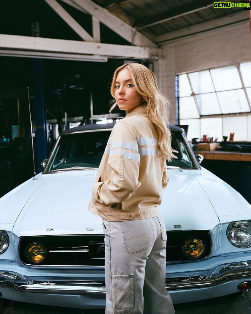 Sydney Sweeney Instagram - ahhhhhhh!!!!!! im super excited to share my newest workwear collection inspired by my new baby, a vintage @fordmustang 💙 #ad Disclaimer: Custom vehicle shown. Not available for sale. Always refer to the owner's manual before performing vehicle maintenance. Limited supply available.