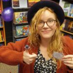 Tamzin Merchant Instagram - It’s #NationalHatDay today! HURRAH! ✨🎩✨ Here’s me wearing TWO hats - one on my head and the other on my thumb! My thumb hat is an amazing tiny work of handmade magic, created by the wonderful seller of books and creator of stunning window displays @literaryvegan 🤩 (And thereafter, a selection of some recent costume hats I have had the honour to have had upon my head.) HAPPY HAT DAY! 🥳✨🎩✨