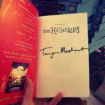 Tamzin Merchant Instagram - I had a very fun evening signing a great pile of special edition copies of #TheHatmakers for @waterstones - as you can see, I wrote my name in the front (properly so you can read it not just a squiggle) and there is a special *exclusive* short story called “Lady Elsa Sets a Trend” in the Waterstones version AND veh veh cool blue edges to the pages. The paperback comes out on January 6th! But you can pre-order it now from Waterstones (link in bio) and give your future self a present 🎁 🥳😘 xx