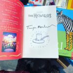 Tamzin Merchant Instagram - It has been an absolute joy this January that #TheHatmakers has been @waterstones Children’s Book of the Month! Seeing my book displayed in the windows of Waterstones stores up and down the country - and so many absolutely smashing, wonderfully imaginative and lovingly-created displays - has been a total thrill. Meeting booksellers who are passionate and brilliant - and keen on my story! - has been so wonderful. I want to say a huge thank you to all the brilliant booksellers who have put The Hatmakers into the hands of readers this month - we made it into the Top 10 in the Children’s Chart! How amazing is that?! Thank you all - booksellers and readers and the brilliant team at @puffinbooksuk - for a truly magical month. Today I visited a Waterstones to see my book being Children’s Book of the Month on its final day. It was glinting in the window beside a Philip Pullman book & I felt indescribably delighted. ALSO… somewhere in London is one book that I signed and ALSO drew a magical hat in (see the final pic in this post). I wonder who’ll find it. ✨🎩✨