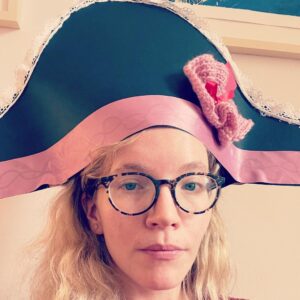 Tamzin Merchant Instagram - It’s #NationalHatDay today! HURRAH! ✨🎩✨

Here’s me wearing TWO hats - one on my head and the other on my thumb! My thumb hat is an amazing tiny work of handmade magic, created by the wonderful seller of books and creator of stunning window displays @literaryvegan 🤩

(And thereafter, a selection of some recent costume hats I have had the honour to have had upon my head.)

HAPPY HAT DAY! 🥳✨🎩✨
