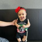 Tecia Torres Instagram - Mommy’s little model 🫶🏽 Having a daughter is everything I thought x1000. I’m so glad Alayah gets to be apart of our careers and experience moms doing what they love… another one of my pregnancy sewing creations … Raquel’s fight shirt turned into a baby onesie #RockNado #JourneyBacktoThrOcgagon #MomsCreations #Familia #MamasTwin