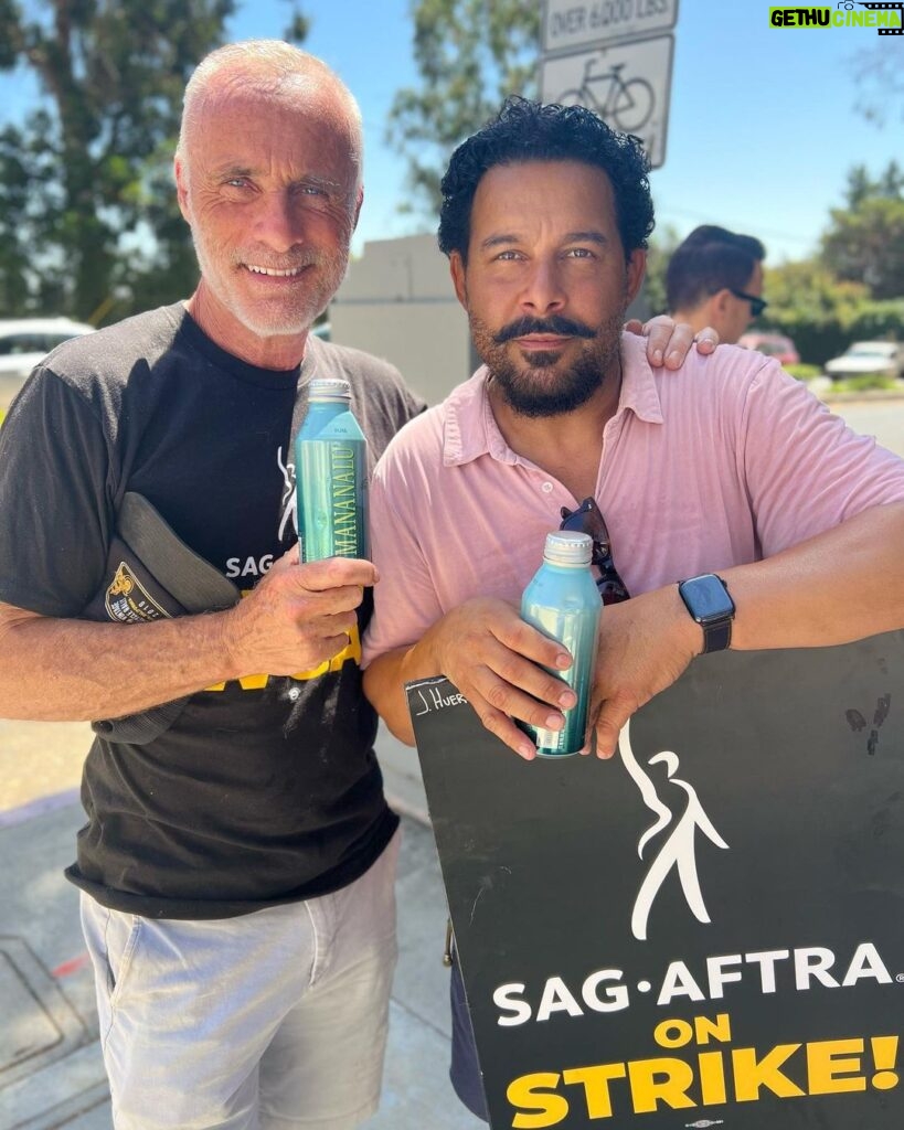 Timothy V. Murphy Instagram - Myself and Jon,walking the picket line,supporting our unions,looking for a fair deal at Fox Studios …oh,and thanks Jay for keeping everyone hydrated @jonhuertas @companyyoukeepabc @prideofgypsies @mananalu.water @sagaftra @writersguildwest #union #unionstrong @sagaftrafound @fox