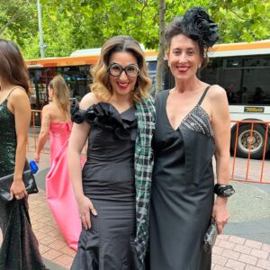 Virginia Trioli Instagram - The beautiful and very moving @ngv summer blockbuster @alexandermcqueen  Mind Mythos Muse uses our extraordinary collection to make sense of Lee’s voracious love of art, design, history, myths, literature, textiles and collaborators. So in that spirit I’m wearing a very special dress I bought in 2004 from the much-lamented Flinders Way.
Anne Valerie Hash @annevaleriehash is an haute couture designer who was a contemporary of Alexander McQueen and was also a star from the get-go. They were exhibited together in the very early days as emerging artists. Like Lee, Anne Valerie started by deconstructing mens suiting, finding a female form within strict, tailored lines. They both knew how to cut - properly, which is more rare than you’d think. I’m lucky enough to own a few McQueen pieces, including an astonishing boned and corseted black watermarked silk jacket. But this amazing dress is such a dream to wear and deserves to be out of the closet!
The headpiece is @neilgriggmillinery from 2005, of silk roses and antique 1920s lace , @lanvin cuff , @anyahindmarch clutch - all my own. It’s a really special show and a great tribute to the imagination and scholarship of @ngv staff, especially @berrydeluxe . Do go see it. A great night. @ngvmelbourne #ngvgala @visitmelbourne #fashion #design #annvaleriehash