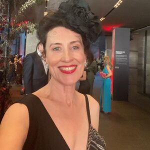 Virginia Trioli Instagram - The beautiful and very moving @ngv summer blockbuster @alexandermcqueen  Mind Mythos Muse uses our extraordinary collection to make sense of Lee’s voracious love of art, design, history, myths, literature, textiles and collaborators. So in that spirit I’m wearing a very special dress I bought in 2004 from the much-lamented Flinders Way.
Anne Valerie Hash @annevaleriehash is an haute couture designer who was a contemporary of Alexander McQueen and was also a star from the get-go. They were exhibited together in the very early days as emerging artists. Like Lee, Anne Valerie started by deconstructing mens suiting, finding a female form within strict, tailored lines. They both knew how to cut - properly, which is more rare than you’d think. I’m lucky enough to own a few McQueen pieces, including an astonishing boned and corseted black watermarked silk jacket. But this amazing dress is such a dream to wear and deserves to be out of the closet!
The headpiece is @neilgriggmillinery from 2005, of silk roses and antique 1920s lace , @lanvin cuff , @anyahindmarch clutch - all my own. It’s a really special show and a great tribute to the imagination and scholarship of @ngv staff, especially @berrydeluxe . Do go see it. A great night. @ngvmelbourne #ngvgala @visitmelbourne #fashion #design #annvaleriehash