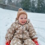 Zoe Sugg Instagram - Ottie’s first snow! (Also I think it’s the first time it’s snowed during vlogmas?) 🌨️ p.s. we did put mittens on her and they lasted all of 5 mins before she shook them off and didn’t want to wear them anymore. HOW do you get toddlers to wear mittens/gloves? 😂🫠