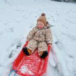 Zoe Sugg Instagram - Ottie’s first snow! (Also I think it’s the first time it’s snowed during vlogmas?) 🌨️ p.s. we did put mittens on her and they lasted all of 5 mins before she shook them off and didn’t want to wear them anymore. HOW do you get toddlers to wear mittens/gloves? 😂🫠