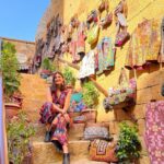 Aahana Kumra Instagram - How can I talk about Rajasthan and not see Colors! 😘🌞 I love how vibrant this state is! And unapologetically! Just like India! It has Colors of all kinds! And that’s what makes this state one of my favourite ever!! 🩷❤️🩵💛💙🧡💚💜 The people, The warmth, The food, The shopping, The experiences! One of a kind! No wonder they say “Padhaaro mhaare des!”🌞🏜️🐪🌞🩷#rajasthan #jaisalmer . . . . #rajasthandiaries #rajasthantourism #aahanakumra #solofemaletraveler #jaisalmerfort #jaisalmerdiaries #jaisalmerdesert #india #incredibleindia #rajasthandiaries #travel #traveltheworld #travelphotography #travelling #travellife #travelgram #instatravel Golden Fort - Jaisalmer