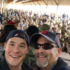 Adam Devine Instagram - HAPPY FATHERS DAY! here’s a pic of me and my pops in Iraq on Christmas Day on a @USO tour. We’ve done a lot of cool things together and been on plenty of adventures but this one was a favorite. You are my sounding board, my confidant, my best friend, my rock. I love you Dad. My dad was diagnosed with Lung Cancer in April and to say it has put myself and our family in a tail spin would be a gross understatement. Hug your fathers and tell them you love them and if they’re happy and healthy count you blessings.
