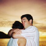 Adam Devine Instagram - Obviously, Cancer SUCKS. The absolute worst. Join me and #StandUpToCancer as we #kisscancergoodbye I know it’s a cute AF campaign and this photo of me kissing my wife is top notch cute but let’s quit staring at the kauuute pic and donate at @su2c. Lets KISS CANCER GOODBYE!