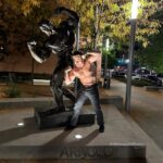 Adam Devine Instagram - Walking though Columbus after a @podimportant live show and saw this statue of @schwarzenegger. It’s crazy that we have the exact same body with no differences. Arnold we hitting the gym soon buddy? #BrothersinSwole