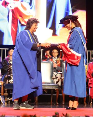 Alex Scott Instagram - Took mama to uni with me 🖤

Thank you @officialqmul for awarding me an Honorary Fellowship for invaluable contribution to the world of sport, social purpose and inclusion… what a special day.

Slide 6: my friend Sarah graduated from the university 25 years ago, I was with her Celebrating her special day, fast forward to the present she came to celebrate with me 🥰