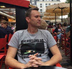 Alexei Navalny Instagram - Нет, не быть мне арестантом, вставшим на путь исправления 😔

Только неделю я на своей уютненькой зоне строгого режима, а мне уже влепили “выговор правами начальника учреждения”.

Объясняю: рапорты, выговоры и поощрения — это важнейшая часть жизни “красных” зон. Этим (понятно, что еще избиениями и пытками) здесь все управляется. Любит тебя администрация — у тебя постоянно поощрения, а значит, передачи и свидания. Не любит — для тебя придумываются нарушения, по ним пишут рапорты и делаются выговоры. Два выговора — могут отправить в ШИЗО. А там запросто и умрешь от “воспаления легких” или сломаешь шею, упав с нар (потом кто-то за это получит поощрение в виде свидания с мамой!)

Выговоры висят на тебе и “сгорают” только через год после последнего.

У меня последний выговор с формулировкой “сломал потолок” (не спрашивайте) был в прошлом августе. Соответственно, в этом августе все мои 30 выговоров должны были “сгореть”.

Но нет! Моя первая зона, оказывается, составила рапорт, что буквально в последние два часа, пока я был у них, я “нарушил форму одежды”. В 6-30 утра шел в умывальник в футболке, а не в тюремной робе.

Чтоб вы понимали: в 6-30 утра все зэки моются-бреются и все идут в умывальник в футболках. Но я-то шел опасно! Я-то шел как экстремист, и моя футболка угрожала действующей власти. Поэтому моя новая зона, рассмотрев письмо старой зоны, вызвала меня на комиссию, осудила за такой беспредел и вынесла новый выговор. Так что и мои 30 прежних выговоров со мной теперь еще на год. Очень удобно — в любой момент меня можно признать злостным нарушителем, кинуть в ШИЗО и т.д.

Мораль: хотите жить опасной жизнью? Просто иногда ходите в футболках 😉