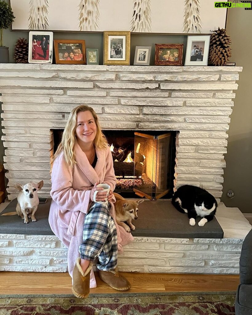 Angela Kinsey Instagram - The only thing that brings Oreo & Biscuit together… a cozy fire on a rainy morning. Photo by Josh who said I looked pretty sitting by the fire. And I said in my old robe I got at Walgreens?? 😂❤