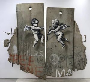 Banksy Instagram - .
Opening my first ever stall at a trade fair next week. I’ve painted a replica separation barrier to promote the Walled Off hotel, ironically the neighbours have complained it’s too tall. We’ll be at the Palestine stand giving away free stuff, World Travel Fair, London Excel centre 6th and 7th November. Free to get in if you register online today and pretend to be a travel agent.