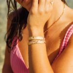 Bethany Hamilton Instagram - Stoked to announce the official launch of the @maecargo x @beautifullyflawedfoundation 3-piece jewelry collection — inspired by faith, Hawaiian lifestyle, and the beauty in flaws! 🌊 🌺 This beautiful line includes an adjustable ring, adjustable bracelet, and easy clasp necklace, all created with the adaptive needs of our Beautifully Flawed Retreat attendees in mind. Over the past few months, Kate, the owner of Mae Cargo, has poured her heart and soul into creating these beautiful pieces, capturing the essence of our retreats for those with limb difference to transform it into wearable art. Not only are these pieces gorgeous and handcrafted with the highest quality to withstand sweat, water, and the ocean, but they serve a greater purpose as well: The purchase of this line directly helps keep our mission of providing hope to overcome through Jesus. By purchasing one or more of these Beautifully Flawed collection pieces, 15% of each order goes back to our foundation to help support our programs for young women and men with limb difference. We are so grateful for Mae Cargo, this special partnership, and couldn’t be more excited for young women to feel adorable wearing this adaptive jewelry line. Link in the @beautifullyflawedfoundation profile to shop now and learn more about the collection! 📷 @taliapasheyphoto #MaeCargo #BeautifullyFlawedFoundation