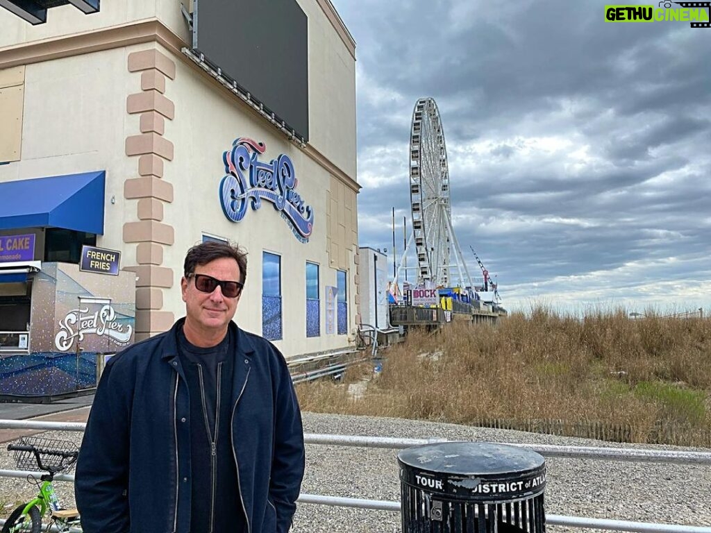 Bob Saget Instagram - Atlantic City. LOVED my two shows @hardrockhcac with @therealmikeyoung - And ironically, it was located right here – where I used to go to as a kid. Steel Pier. It’s hard to believe that when I came here at nine years old, staying every summer at my grandparents, who lived not far inland from this very spot, this pier did not end where it does today. Nor did it look like this. It was amazing. Sure, arcade games, bumper cars, but mainly major showrooms with the biggest acts. It’s now 1000 feet long with some amusement rides but it was 2000 feet long when I used to go to it— And, like I said, it had the biggest names in show business performing. At nine years old I got to see the original Temptations and the original Four Tops on the same bill. My grandparents also took me to see Ricky Nelson there. I got to stand on the side of the pier and watch a helicopter take Ricky Nelson away to his next destination. At the very end of the pier they used to have a diving horse. Thank God they stopped that tradition. But it was also at the end of that pier there was a ballroom where I stood, at 10 years old, next to a drummer who had a small trio— and people were dancing— but the room was pretty empty. That drummer was the legendary Gene Krupa, one of the best drummers who has ever lived. I remember him staring at this kid – me – 10 years old, realizing I was seeing something amazing— watching him play. Memories of what that used to be, years after what was shown on “Boardwalk Empire,” but still remnants of those times existed back then in the 60’s. It was nice to stroll the boardwalk today and see people out, most wearing masks and still enjoying themselves. It felt so good to be here and get to do my first shows in a long time for people who I’m told can’t wait to get out and experience live comedy for the first time here in a long long time. Thanks Hard Rock and thanks Atlantic City. Such wonderful audiences. Hard Rock Hotel & Casino Atlantic City