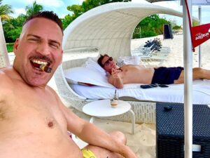 Bob Saget Instagram - Last day in Grand Cayman and the last night of shooting our movie with a wonderful cast, including this handsome devil – @therealravina - Then it’s back to reality – – Masks, second dose of vaccine, and as much stand-up as I can put out there. Will be great to make people laugh again.
