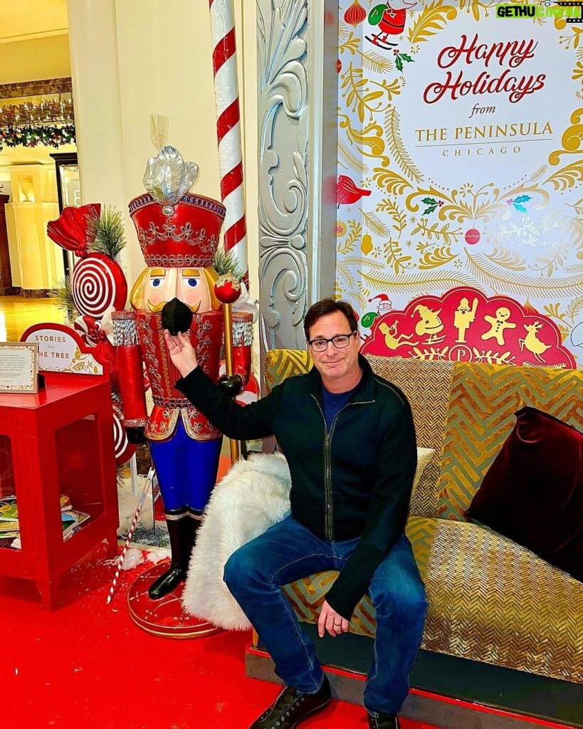 Bob Saget Instagram - Happy Holidays everyone. Here am I putting my mask on a nutcracker. Nothing says Merry Christmas 2021 like this photo. Thanks @thepeninsulachi for the hospitality. And thanks @eattravelrock for the photo and, oh yeah, for bein’ my wife. And thanks to your wonderful family for all the lovely gifts. The biggest one being you. Aw. 🎄💖