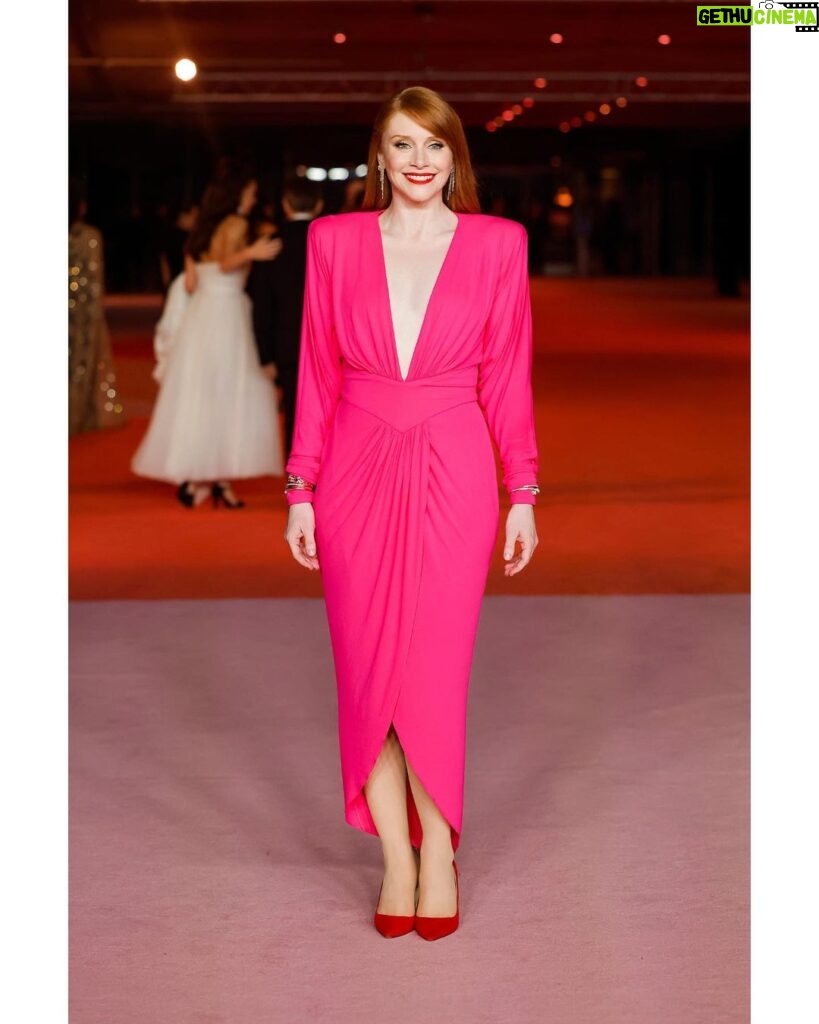 Bryce Dallas Howard Instagram - Thank you @academymuseum! 💕🦩 #AcademyMuseumGala ⁣ ⁣ Hair: @misterjasonlow⁣ Makeup: @vivianbaker⁣ Nails: @chuenails⁣ Styled by Publicist Extraordinaire: @alex.schack⁣ Dress: @alexandrevauthier⁣ Shoes: @jimmychoo Jewelry: @shycreationfinejewelry⁣ ⁣ 📸: 1-4: @andiejjane 📸 5-6: @academymuseum/ @gettyimages ⁣ [ID: Standing on the red carpet at the Academy Museum, BDH smiles and wears a fuscia dress and red shoes.] Academy Museum of Motion Pictures
