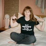 Bryce Dallas Howard Instagram - Mercury is Retrograde! In Virgo! To use the words of astrologer and writer @chaninicholas, “Good luck to us all!”⁣⁣ ⁣ 📸: Andie Jane (@andiejjane)⁣⁣ ⁣⁣ [ID: BDH sits cross-legged on top of a fluffy white comforter. She points to her black t-shirt which reads, “but mercury is in retrograde.”]