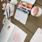Bryce Dallas Howard Instagram - In Paradise 🌸 with my “Flowers, Feathers, & Animal Friends” ⁣ ⁣ Thank you Sarah (a.k.a @themintgardener) for yet another magical #WatercolorWorkbook – you make it so easy to put paint to paper and I can’t wait to fill every single page 💕⁣ ⁣ 📸: Andie Jane (@andiejjane)⁣ ⁣ [ID: Sitting at an outdoor patio table on a sunny day, BDH paints a pink and red rose in Sarah Simon’s new watercolor workbook, “Flowers, Feathers, & Animal Friends.” She wears a white t-shirt, glasses, and her hair down.]