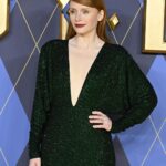 Bryce Dallas Howard Instagram - London, you make my heart so full! ❤️ #ArgylleMoviePremiere⁣ ⁣⁣ 📸: Getty Images for Universal Pictures Hair: @cwoodhair⁣⁣ Makeup: @karayoshimotobua⁣⁣ Styled by Publicist Extraordinaire: @alex.schack⁣⁣ ⁣⁣ [ID: In front of blue and yellow Argylle-themed backdrops, BDH poses for photos at the UK premiere of #ArgylleMovie. She wears a long, glittering emerald green dress with a deep v-neckline and deep crimson lipstick. Her straightened hair falls behind her back to show off her earrings.] Odeon Luxe Leicester Square