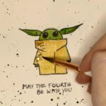 Bryce Dallas Howard Instagram – #MayTheFourthBeWithYou 💫💚 Swipe to see the making-of 👉🏻 ⁣⁣
⁣⁣
#TheMandalorian #BabyYoda #StarWars ⁣⁣
⁣⁣
[ID: Showing off her new Grogu watercolor painting, BDH makes a kiss face]