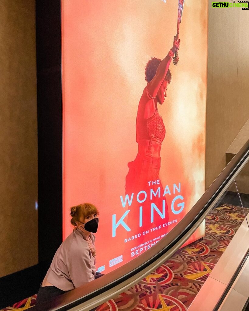 Bryce Dallas Howard Instagram - All hail #TheWomanKing 🧡 Congratulations to the WARRIORS who brought this extraordinary film to life. The POWER of @womankingmovie is unparalleled — from the incredible action sequences to the deeply affecting performances to the sheer CINEMA of it all. This was an unforgettable experience and I am in such awe. Online family, do not miss out on this movie!! It’s not every day that our lives are changed and that’s what The Woman King has the power to do. Support Black women and exceptional storytelling at the box office and get your tickets TODAY 👑⁣ ⁣ [ID 1-2: BDH kneels before a massive poster for “The Woman King” at AMC Theater. On the poster, Viola Davis as Nanisca powerfully raises a machete above her head]⁣ ⁣ [ID 3: About to watch one of her new favorite films, BDH points at the AMC movie marquee for a screening of “The Woman King.” She wears black leggings, a lavender sweater, and her hair in two twisted buns]