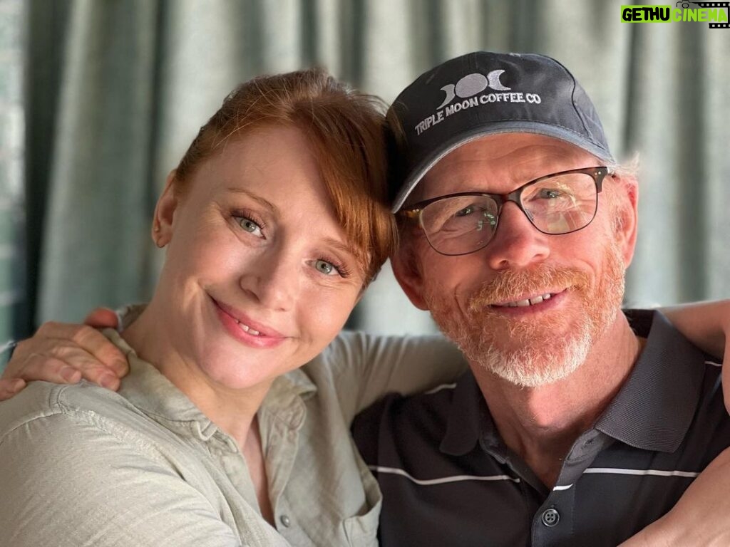 Bryce Dallas Howard Instagram - Happy Labor Day from two proud union members 💪 We are the beneficiaries of incredible advocacy work from @directorsguild, @sagaftra, @wgawest, @producersguild, and @iatse 💛 Thank you unions for keeping us protected (and for the extra day to hang out with my pops!) ⁣ ⁣ [ID: A medium close up photo of BDH and Ron Howard hugging as they smile at the camera. BDH wears a light green linen shirt and her hair in a ponytail. Her dad wears a black polo shirt with white stripes and a black Triple Moon Coffee Co baseball cap]