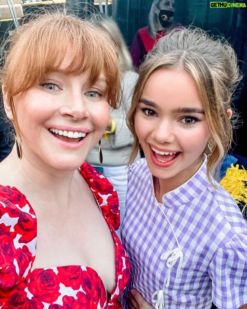 Bryce Dallas Howard Instagram - Happy Birthday @iamizzysermon! 🎊🥳 Watching you grow into the radiant, funny, insightful, and kind young woman that you are has been one of the greatest joys of being your on-screen mum 🥹 ⁣ ⁣ [ID: Doing press for Jurassic World Dominion, BDH and Izzy, smiling cheek to cheek, take a selfie together. BDH wears a dress with a red rose print and Izzy wears a lilac checkered dress.]
