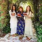 Bryce Dallas Howard Instagram - Thank you @sweetlaurelbakery for the delicious treats 💖 I never knew how soothing cake decorating could be… and next time I’ll start my design with the end in mind 😅 I hope The Great British Bake Off would be proud.⁣⁣ ⁣⁣ @laurelgallucci and @clairethomas, it’s always a joy to hang out with you and I can’t wait for Sweet Laurel to grace the shelves of our grocery stores soon! ⁣⁣ ⁣⁣ [ID 1: Living her cottage-core dreams, BDH stands between Laurel Gallucci and Claire Thomas (co-founders of Sweet Laurel Bakery) in a picturesque garden. They each hold a chocolate cake decorated with roses and raspberries.]⁣⁣ ⁣⁣ [ID 2-3: BDH twirls and shows off her new Sweet Laurel apron and canvas tote.]⁣⁣ ⁣⁣ [ID 4: A stack of Sweet Laurel Bakery’s upcoming chocolate cake, pancake, and scone mix boxes.]