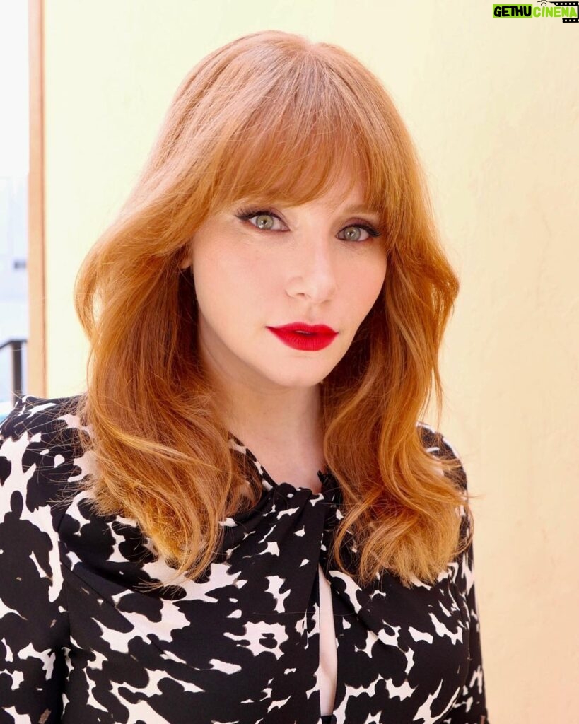 Bryce Dallas Howard Instagram - 💋💋💋⁣ ⁣⁣ Makeup: Kate Synnott (@katesynnottmakeup)⁣ ⁣ Hair: Bobby Eliot (@bobbyeliot)⁣⁣ Dress: @altuzarra⁣ Shoes: @ysl ⁣ 📸: Bobby Eliot⁣ ⁣ [ID: Taking advantage of the sunny day outside, BDH poses in a flowy, black and white tortoise-print midi dress. She pairs the outfit with tall black heels and her favorite shade of red lipstick]