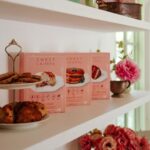 Bryce Dallas Howard Instagram - “Keep pouring,” they said 🤣 Upgrading my Sunday brunch game with @sweetlaurelbakery’s simple and delicious pancake mix 💕 Gluten-free, dairy-free, and paleo, there’s no going wrong here — place your order today at Sweet Laurel’s website in my bio:)⁣ ⁣ (not an ad, just a MASSIVE fan!)⁣ ⁣ [ID: BDH is living out her breakfast dreams as she pours a pitcher of syrup over a stack of Sweet Laurel pancakes. Smiling, she wears a navy dress with a peach and white floral pattern.]