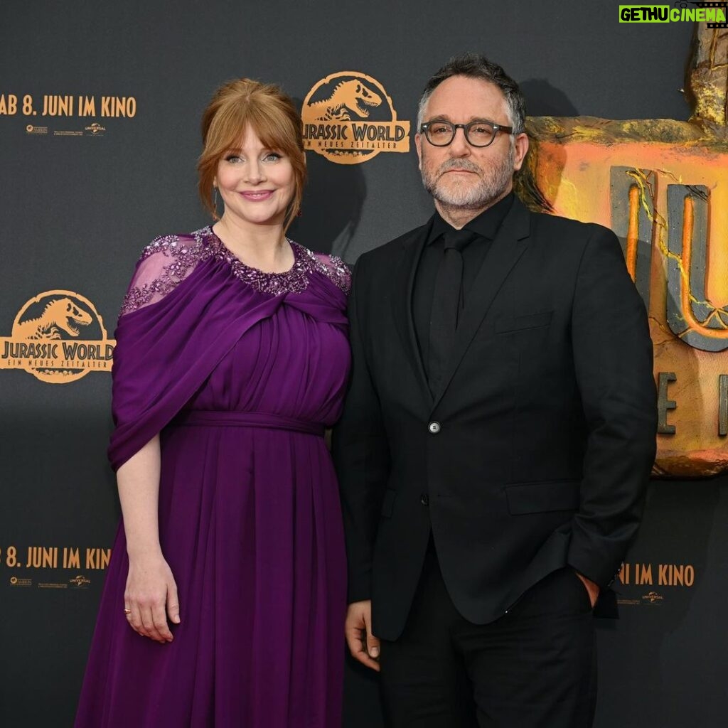 Bryce Dallas Howard Instagram - Happiest of birthdays to two fellas I adore ❤️ No one can crush a karaoke session like Colin Trevorrow (that professional opera training really comes in handy) or a DJ set like Frank Marshall (a.k.a. “DJ Master Frank”) ⁣⁣ ⁣⁣ Colin & Frank, working — and partying — with you is always a good time. I hope your birthday is just as special 🥳⁣⁣ ⁣ 📸: @universalpictures⁣ ⁣⁣ [ID 1: BDH, Frank Marshall, and Laura Dern are all smiles at the LA premiere of Jurassic World Dominion. Unbeknownst to Frank, BDH makes a bunny ears gesture behind his head.]⁣⁣ ⁣⁣ [ID 2: BDH, wearing a plum floor-length gown, and Colin, sporting an all-black suit, stand together for a photo at the premiere of Jurassic World Dominion in Germany.]